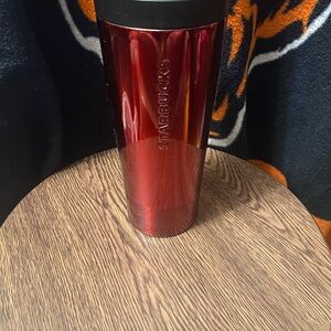 Starbucks metallic red 16 oz stainless steel tumbler with flip up lid. Used